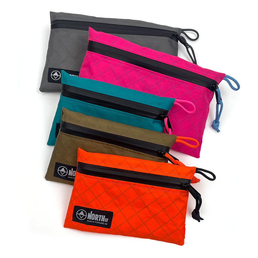 Set of colorful pouches with a brand logo on a white background all-groups
