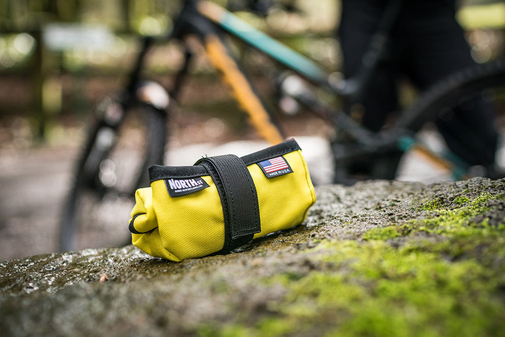 Yellow Tool Roll on a rock next to a trail. - North St. Bags all-groups