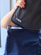 Woman pulling a laptop sleeve out of a bag. all-groups