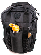 Detail view of a black travel backpack showing water bottle sleeve and front zipper pocket on a white backrgound. 